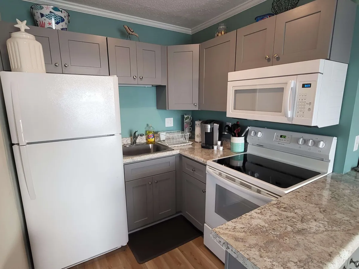 A cozy, functional kitchen with granite countertops, modern appliances, and ample cabinet storage. The setup is practical yet inviting, ideal for preparing family meals or experimenting with new recipes.